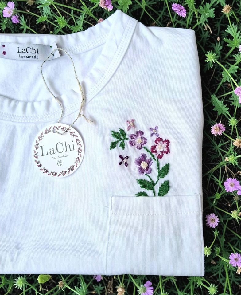 T-shirt with hand-embroidered flowers and beads that peek out from the pocket