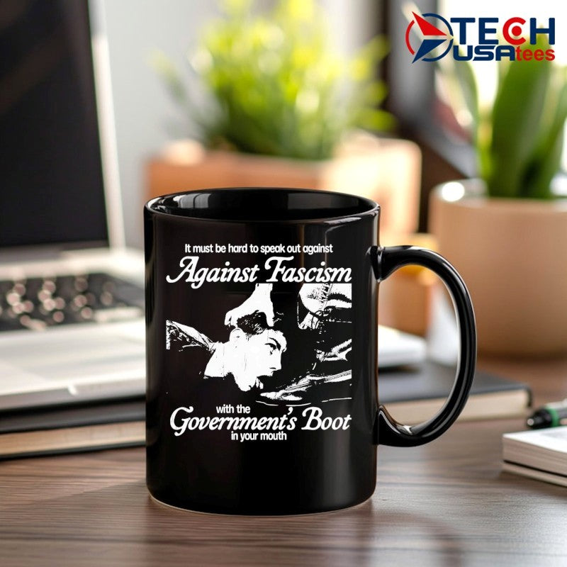 It must be hard to speak out against against fascism with the Government’s Boot in your mouth shirt
