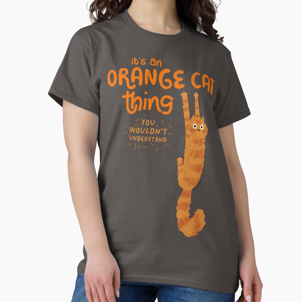 It's An Orange Cat Thing - Funny Tabby Cat Holding On with Claws by Jenn Inashvili